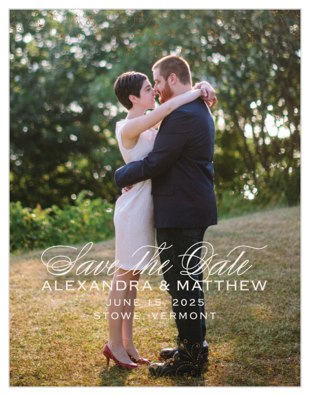 Floral Filigree Save-the-Date Cards feature one of your beautiful engagement photos as their background, a typeface duo made up of a flowing script and modern marking, and delicate, ornate markings along the top and bottom borders in a classic bronze.