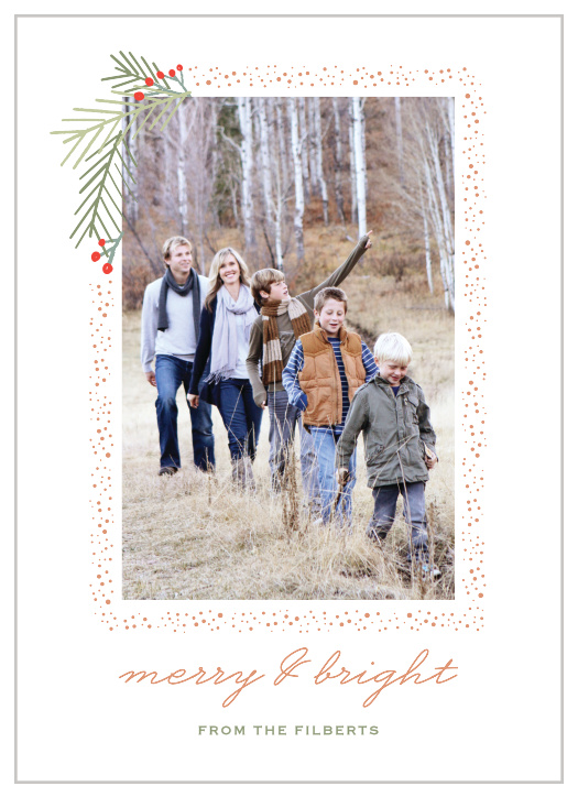 Snow frames your family portrait with a holly flourish on the top left corner of the Pine Branches Foil Photo Holiday Cards. 