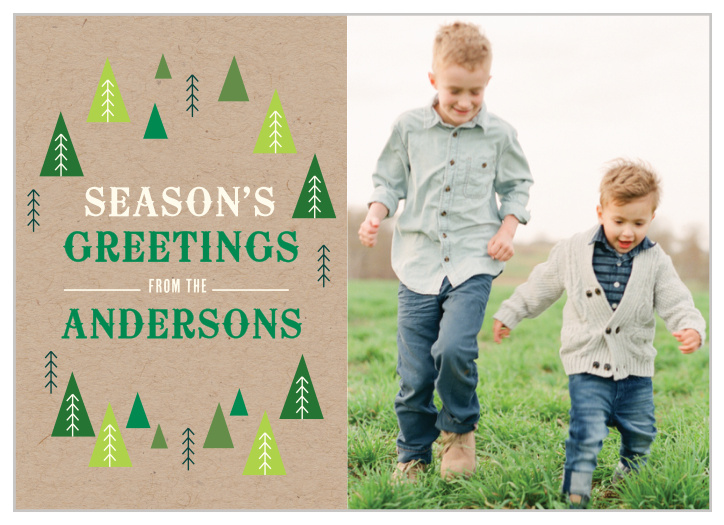 Your seasonal greeting is placed upon a craft paper styled background and framed within multicolored evergreen tree designs next to your portrait. 