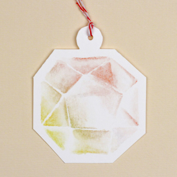 These gift tag printables in the shapes of colorful Gemstones will adorn any of your holiday packages and gifts. This printable template comes with 5 unique gift tag designs in a variety of pretty colors. There is plenty of room for a personal message on the back of the gift tag. All you have to do is download the PDF and print the file via Adobe Acrobat. Cut out the different shapes, punch a hole in the top and attach a fun piece of twine. Have fun!! 